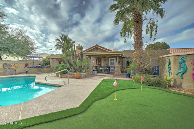 view of swimming pool with a patio and an outdoor bar