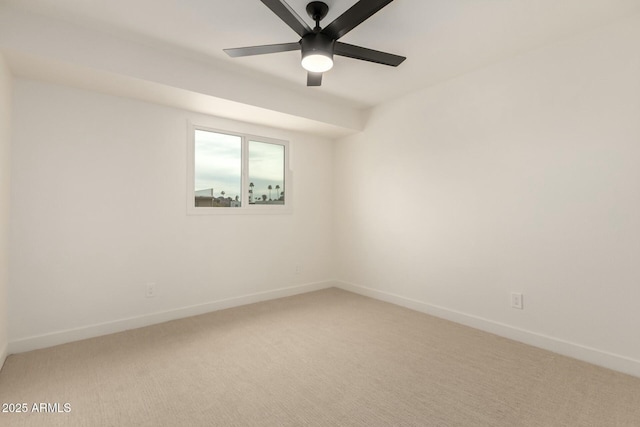 unfurnished room featuring light carpet, ceiling fan, and baseboards