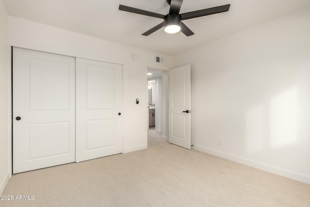 unfurnished bedroom featuring light carpet, baseboards, visible vents, ceiling fan, and a closet