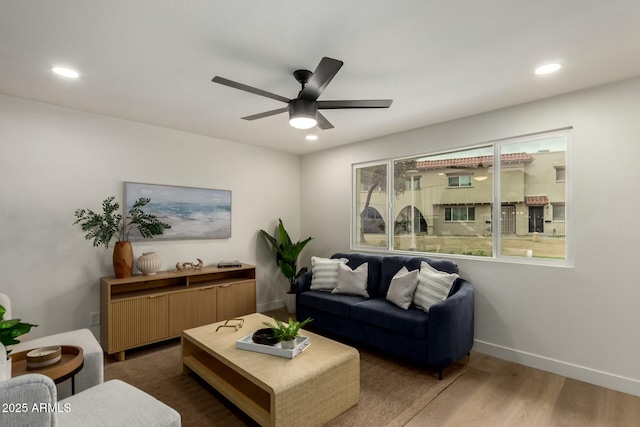 living room featuring recessed lighting, baseboards, and wood finished floors