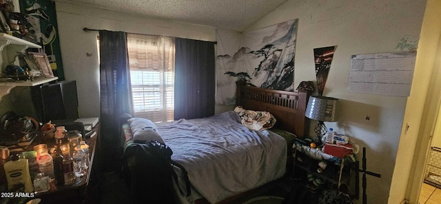 bedroom featuring vaulted ceiling and a textured ceiling