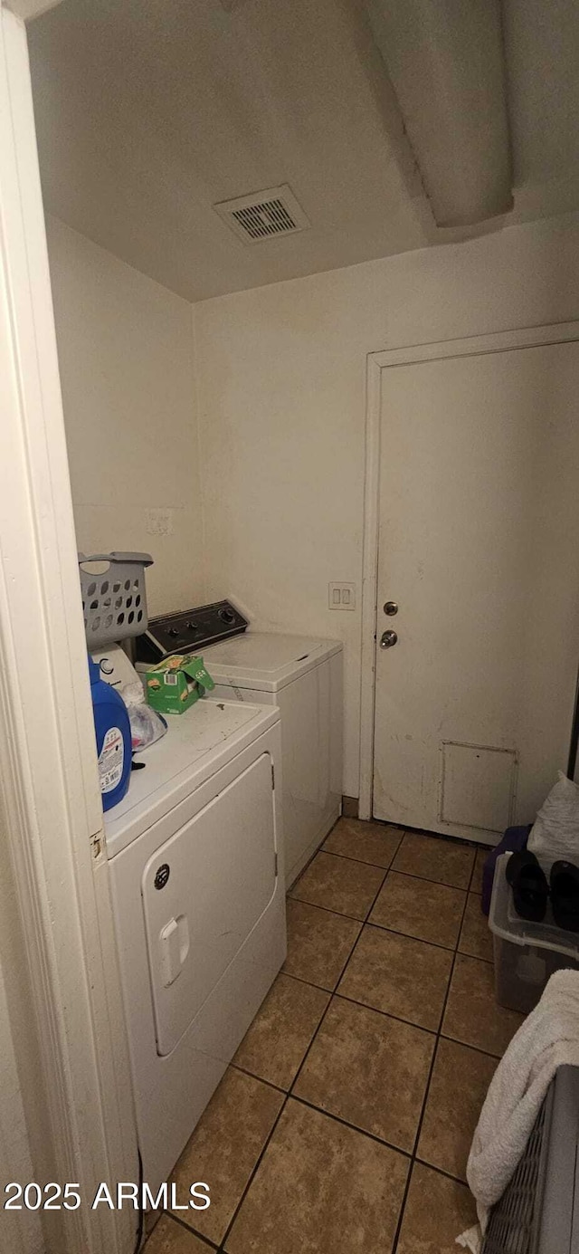 washroom with tile patterned flooring and washing machine and clothes dryer