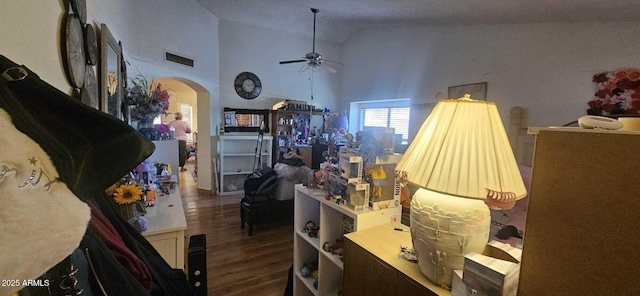 interior space with ceiling fan, dark hardwood / wood-style floors, and high vaulted ceiling