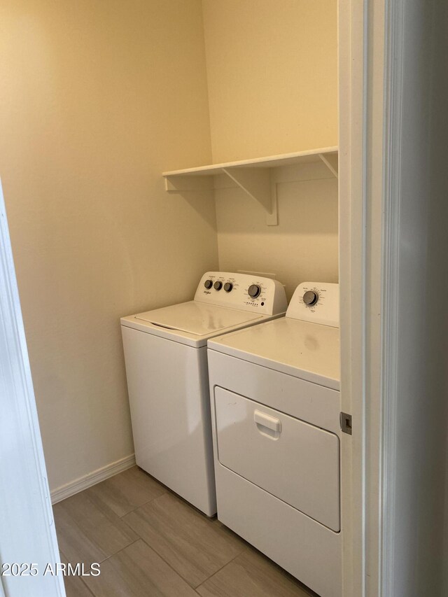 2181 N 211th Dr, Buckeye, AZ 85396 - laundry room featuring washing machine and dryer, baseboards, and light wood finished floors