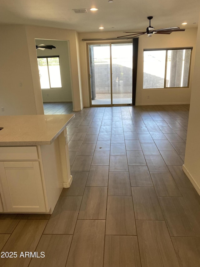 2181 N 211th Dr, Buckeye, AZ 85396 - empty room featuring a ceiling fan, baseboards, wood tiled floors, and recessed lighting