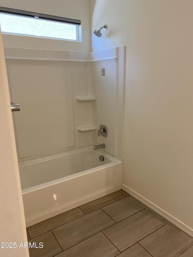 2181 N 211th Dr, Buckeye, AZ 85396 - full bathroom with shower / bathtub combination, wood finished floors, and baseboards