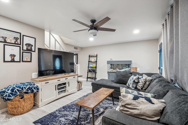 living room with ceiling fan and light hardwood / wood-style flooring