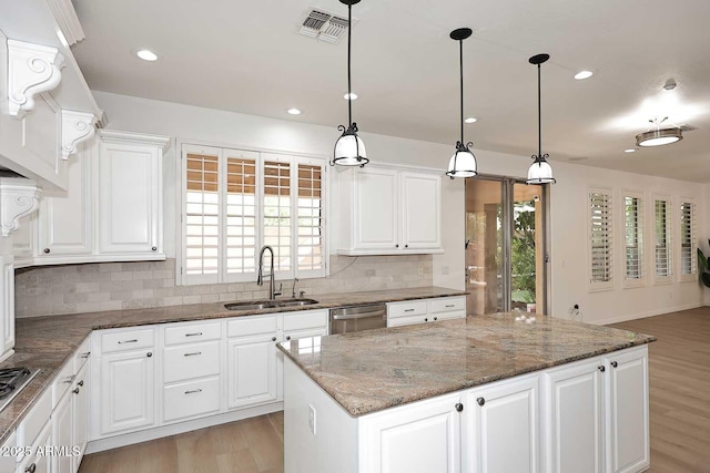 3931 E Crest Ln, Phoenix, AZ 85050 - kitchen featuring a sink, stainless steel appliances, a center island, tasteful backsplash, and light wood-style flooring