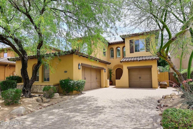 3931 E Crest Ln, Phoenix, AZ 85050 - mediterranean / spanish house with stucco siding, a garage, a tiled roof, and decorative driveway