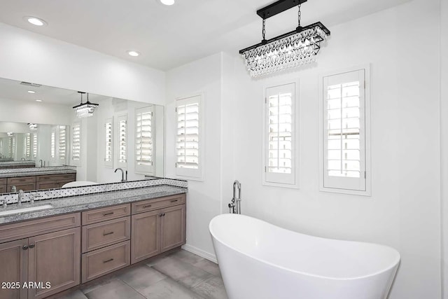 3931 E Crest Ln, Phoenix, AZ 85050 - full bath featuring a soaking tub, double vanity, recessed lighting, and baseboards