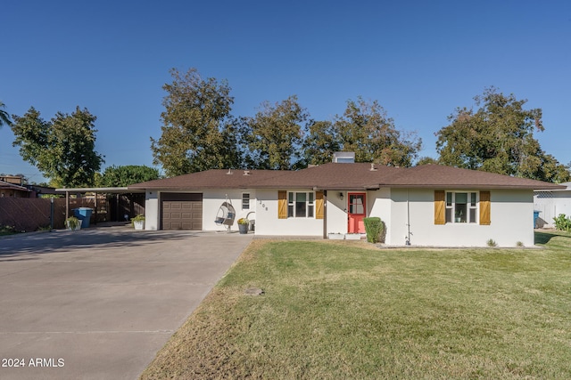 ranch-style house featuring a front lawn and a garage