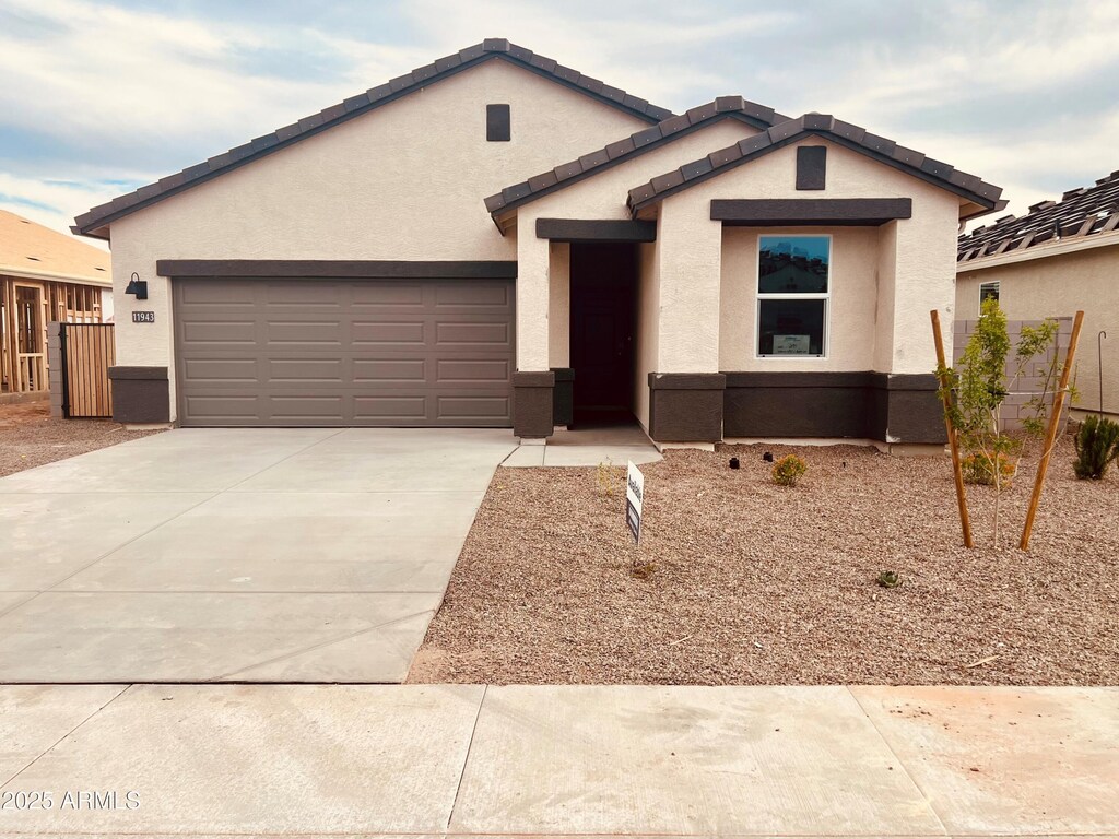 11943 E Aster Ln, Florence, AZ 85132 - ranch-style house with concrete driveway, stucco siding, fence, and an attached garage