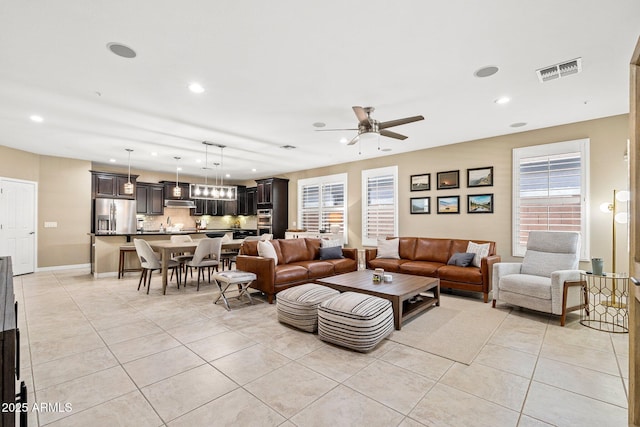 living room featuring visible vents, light tile patterned floors, baseboards, ceiling fan, and recessed lighting
