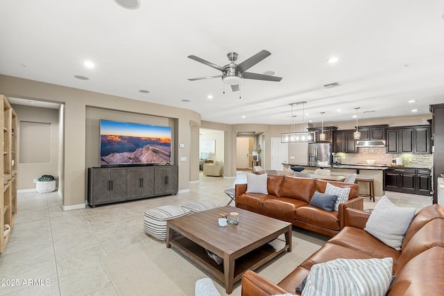 living area featuring visible vents, baseboards, light tile patterned floors, ceiling fan, and recessed lighting