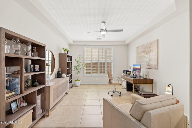 home office featuring light tile patterned floors, baseboards, and a ceiling fan