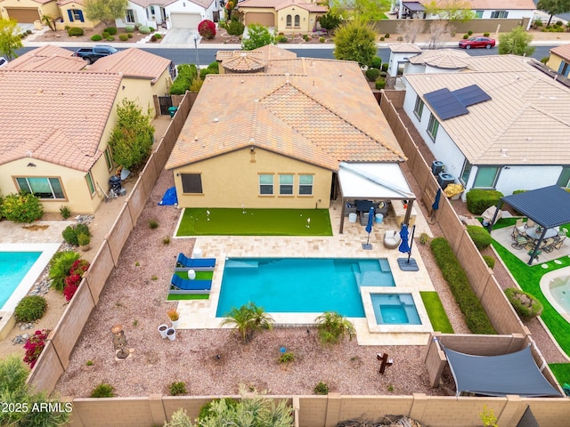 view of pool featuring a fenced in pool, a residential view, a fenced backyard, and a patio area