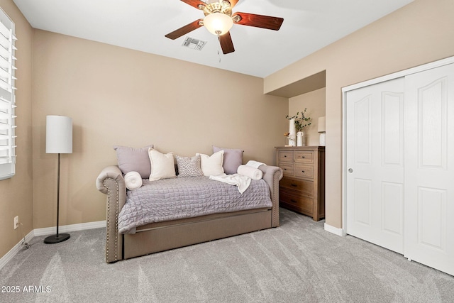 bedroom with visible vents, baseboards, a closet, a ceiling fan, and carpet floors