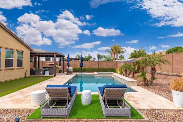 view of pool featuring a fenced backyard, a pool with connected hot tub, and a patio area