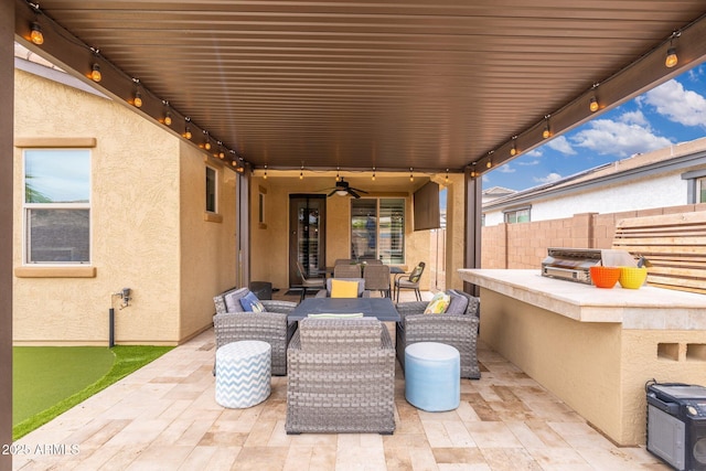 view of patio featuring outdoor dining area, ceiling fan, fence, and an outdoor hangout area