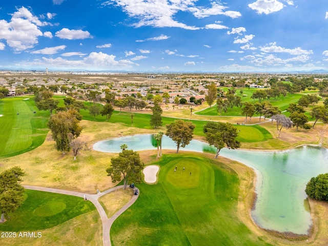 drone / aerial view with view of golf course and a water view