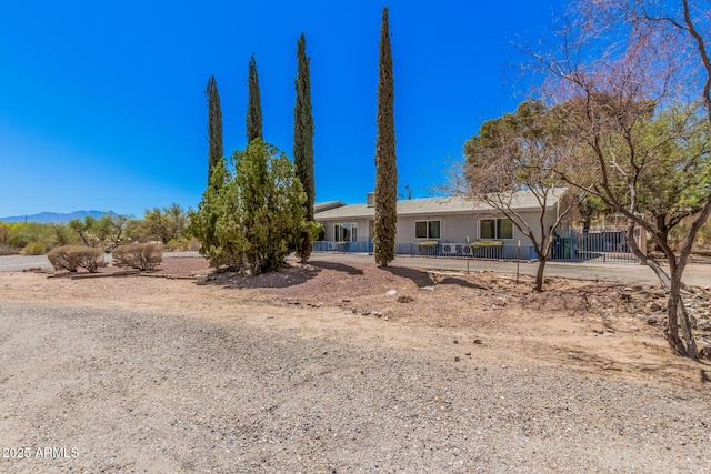 view of front of house featuring a mountain view and fence