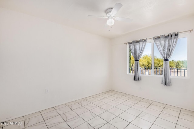 unfurnished room featuring a healthy amount of sunlight and a ceiling fan