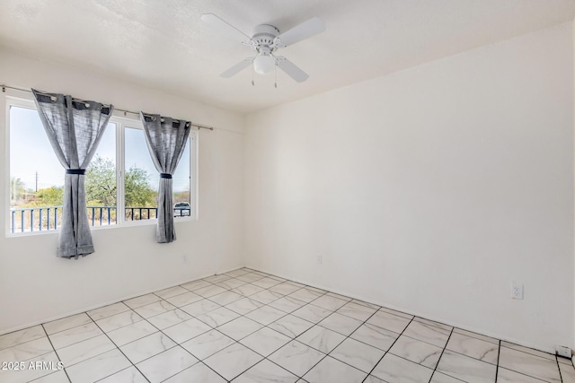 spare room with a ceiling fan