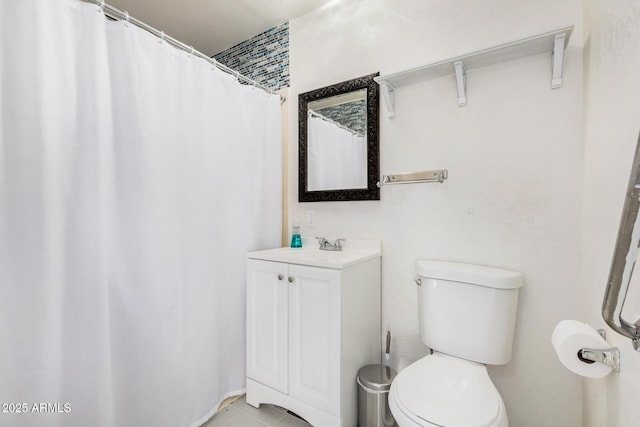bathroom featuring vanity, tile patterned flooring, toilet, and curtained shower