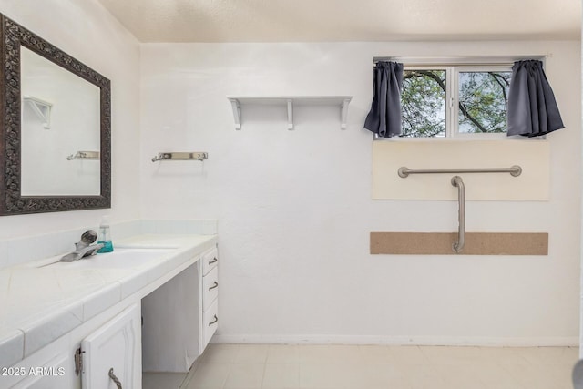 bathroom featuring vanity and baseboards