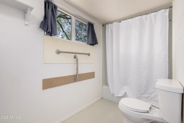 bathroom with toilet, baseboards, and shower / bath combination with curtain