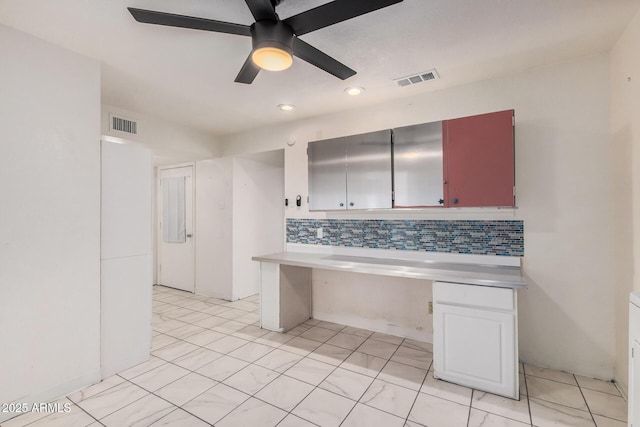 kitchen featuring light countertops, ceiling fan, visible vents, and decorative backsplash