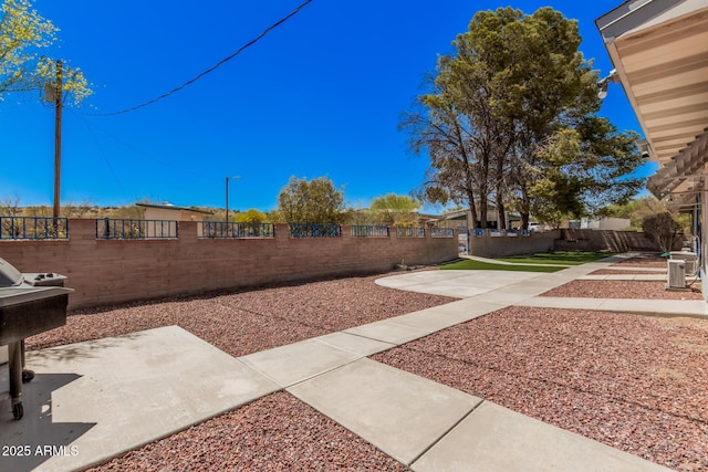 view of yard featuring fence and a patio area