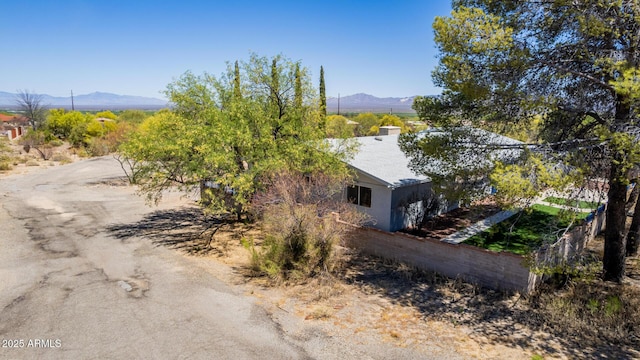 view of side of home with a chimney and a mountain view