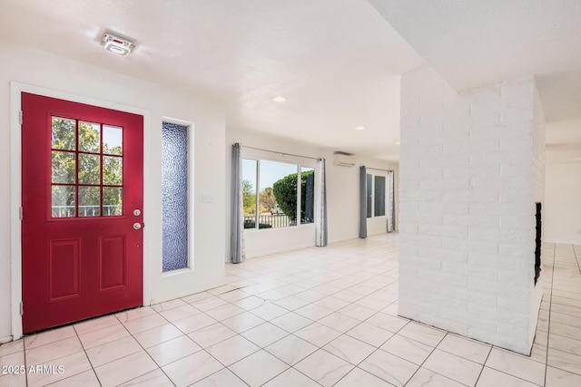 foyer entrance with recessed lighting and light tile patterned floors