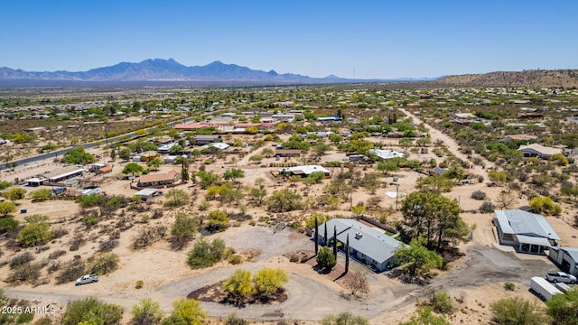 birds eye view of property featuring a mountain view, view of desert, and a residential view