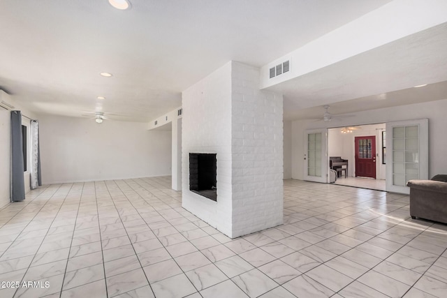 unfurnished living room featuring ceiling fan, a brick fireplace, recessed lighting, and visible vents