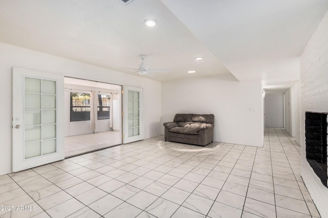 sitting room with ceiling fan, a fireplace, french doors, and recessed lighting