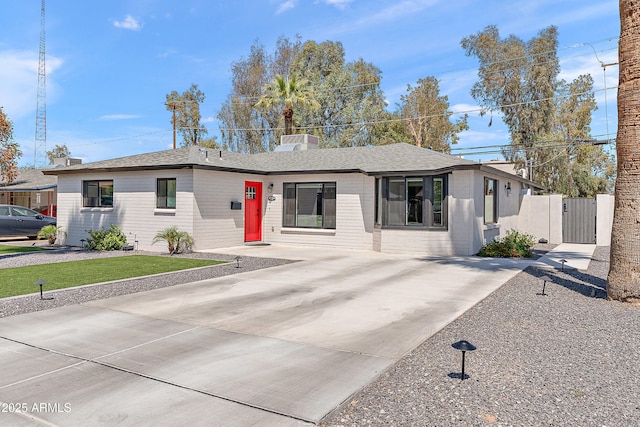 single story home with fence, driveway, and a gate