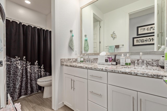 bathroom featuring vanity and toilet