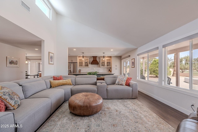 living area with plenty of natural light, wood finished floors, and visible vents