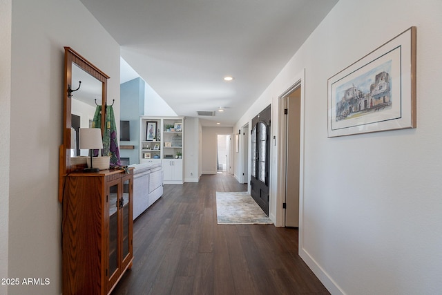 hallway featuring recessed lighting, baseboards, dark wood-style floors, and visible vents