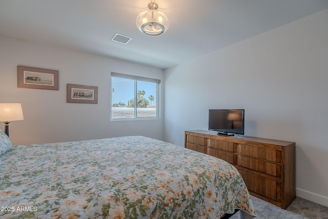 carpeted bedroom featuring baseboards and visible vents