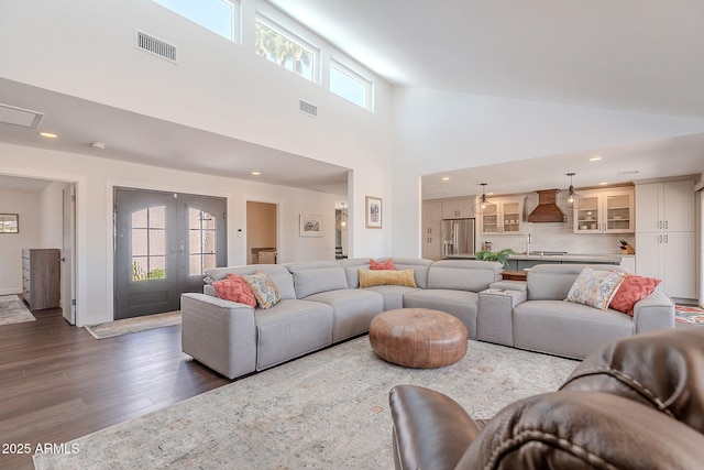 living area with recessed lighting, french doors, visible vents, and dark wood finished floors
