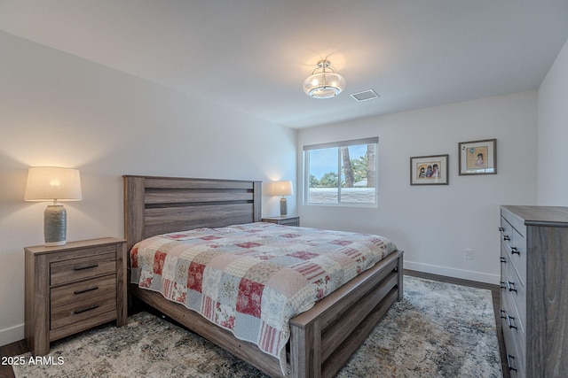 bedroom featuring baseboards, visible vents, and light wood finished floors