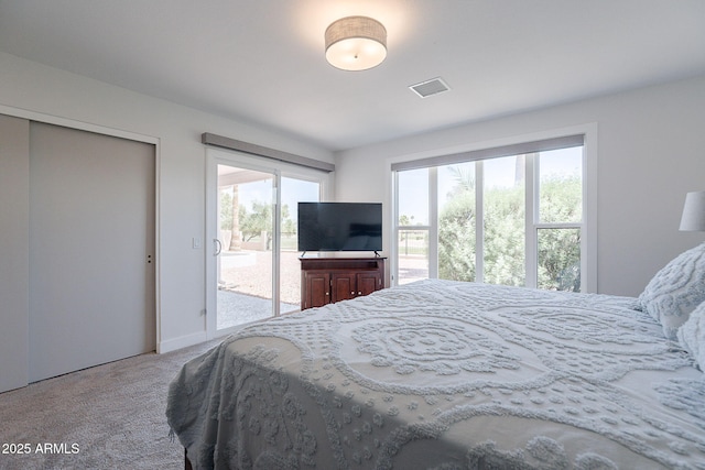 carpeted bedroom with visible vents and access to exterior