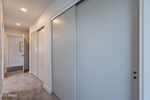 corridor featuring baseboards, carpet flooring, and recessed lighting