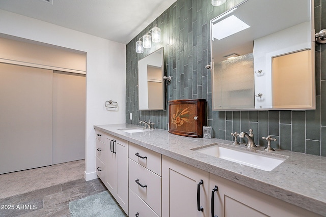 full bath featuring double vanity, a sink, and tasteful backsplash