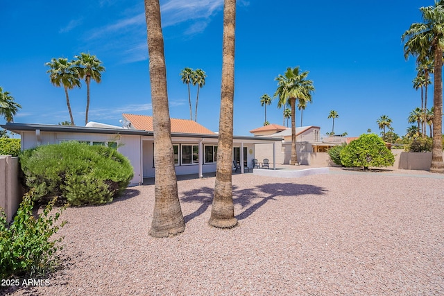 ranch-style home with fence and a patio