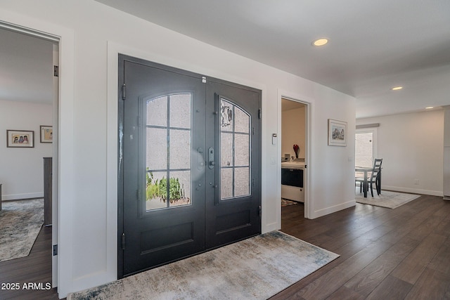 entryway featuring plenty of natural light, french doors, and dark wood-style floors