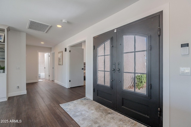 foyer featuring visible vents, baseboards, dark wood-style floors, and french doors